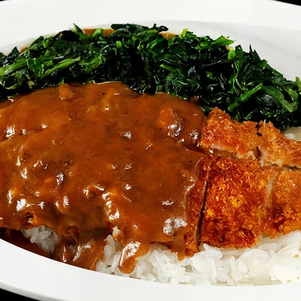 Nippon Curry's chicken katsu curry with rice and a side of green vegetables.